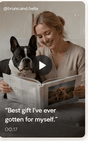 Pet parent holding a photobook with a black and white dog