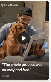 Pet parent looking at a framed pet photo